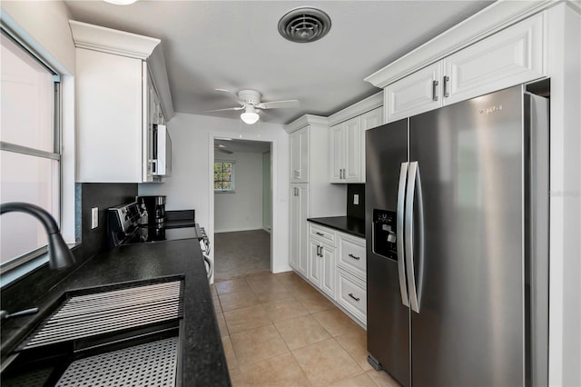 kitchen featuring light tile patterned floors, ceiling fan, stainless steel appliances, white cabinets, and sink