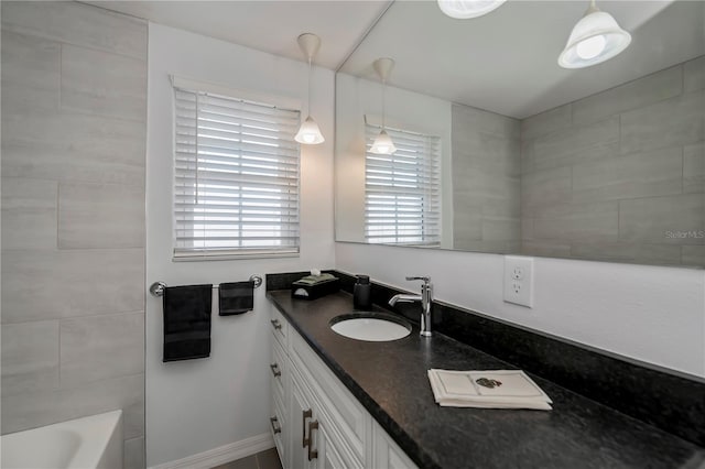 bathroom featuring tiled shower / bath combo and vanity