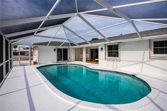 view of swimming pool featuring a patio and glass enclosure