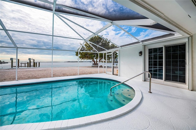 view of pool with glass enclosure and a patio