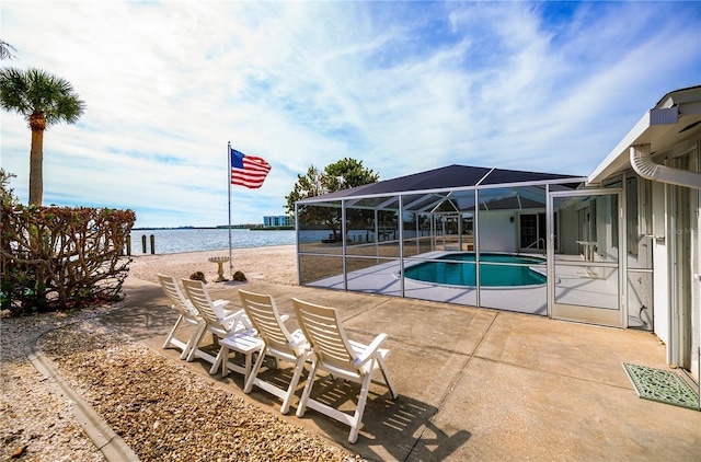 view of pool featuring a lanai, a water view, and a patio