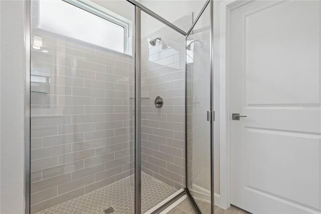 bathroom featuring a shower with shower door