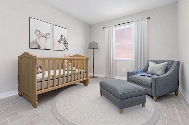 bedroom featuring a nursery area and hardwood / wood-style floors