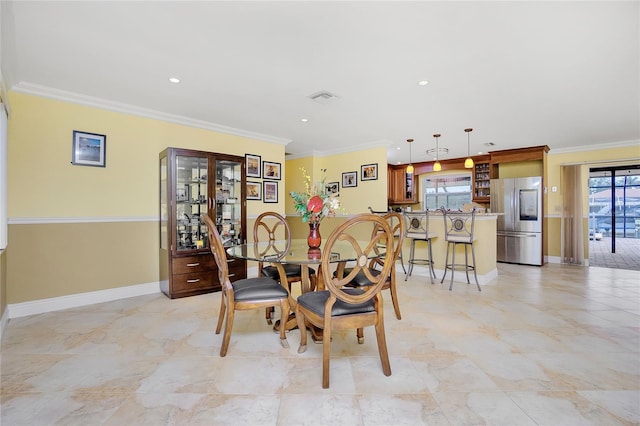 dining space with ornamental molding