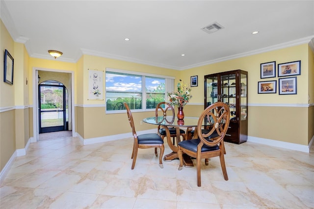 dining area featuring a wealth of natural light and ornamental molding