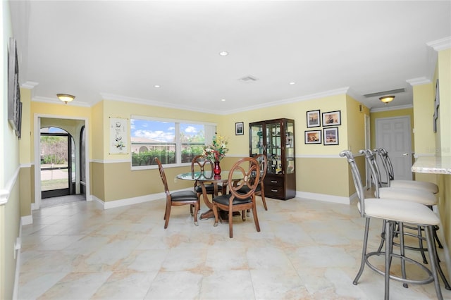 dining space with crown molding