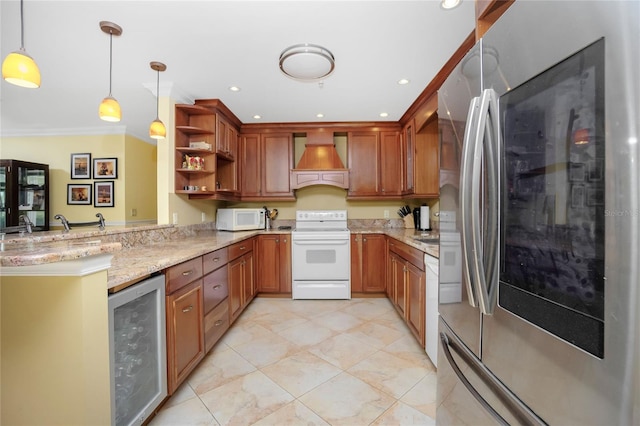 kitchen with white appliances, beverage cooler, custom exhaust hood, hanging light fixtures, and kitchen peninsula