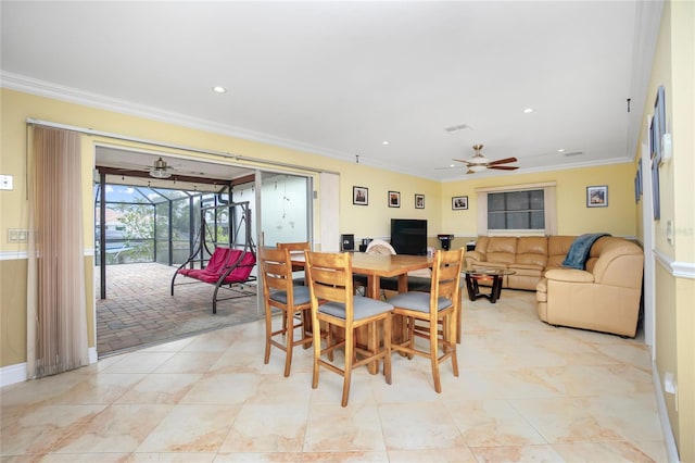 dining area featuring ceiling fan and ornamental molding