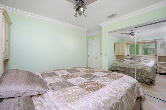 tiled bedroom with ceiling fan, crown molding, and a closet