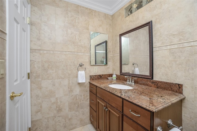 bathroom featuring tile walls, vanity, and ornamental molding