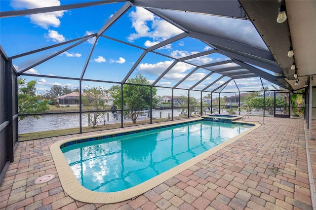 view of pool with a patio area, a lanai, an in ground hot tub, and a water view