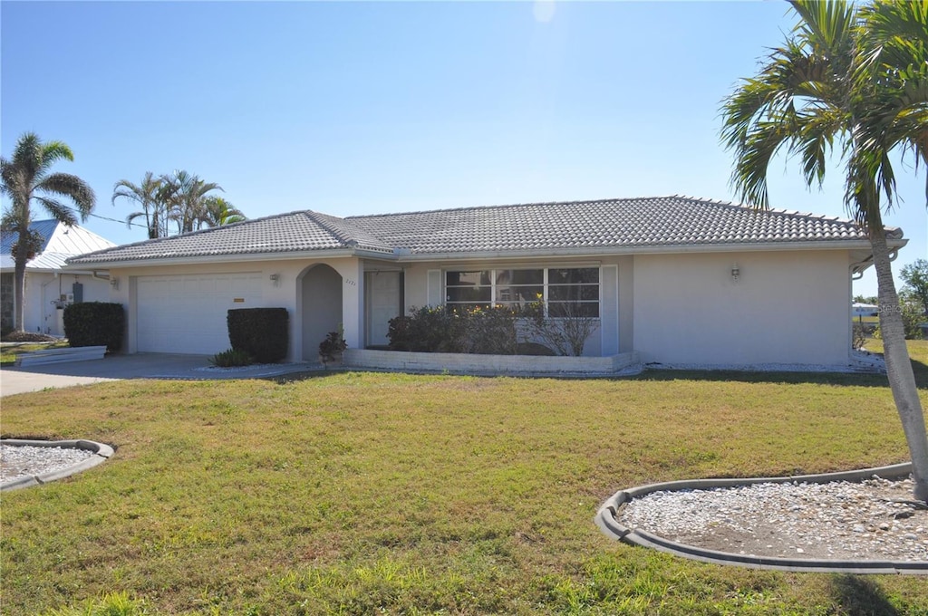 view of front of property with a garage and a front lawn