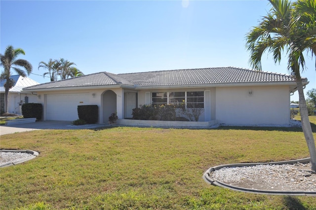 view of front of property featuring a garage and a front yard