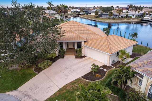 view of front facade featuring a water view and a garage