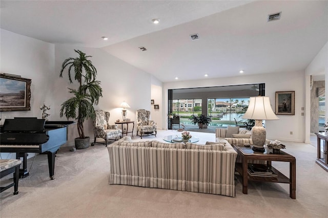 carpeted living room with lofted ceiling