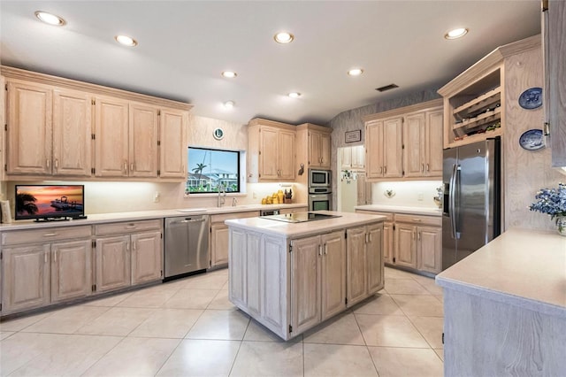 kitchen with light brown cabinetry, a center island, light tile patterned flooring, and appliances with stainless steel finishes