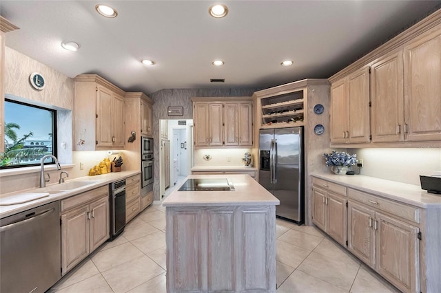 kitchen with a center island, sink, light tile patterned floors, light brown cabinetry, and stainless steel appliances