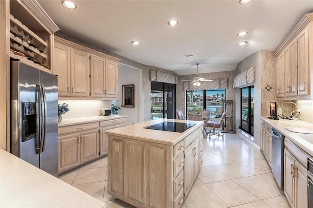 kitchen featuring appliances with stainless steel finishes, ceiling fan, pendant lighting, light brown cabinets, and a center island