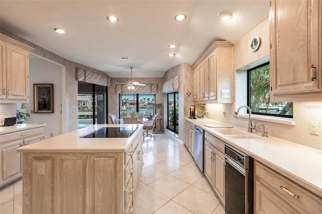 kitchen featuring stainless steel dishwasher, black electric cooktop, sink, light brown cabinets, and a kitchen island