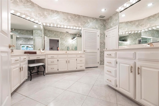 bathroom featuring tile patterned flooring and vanity