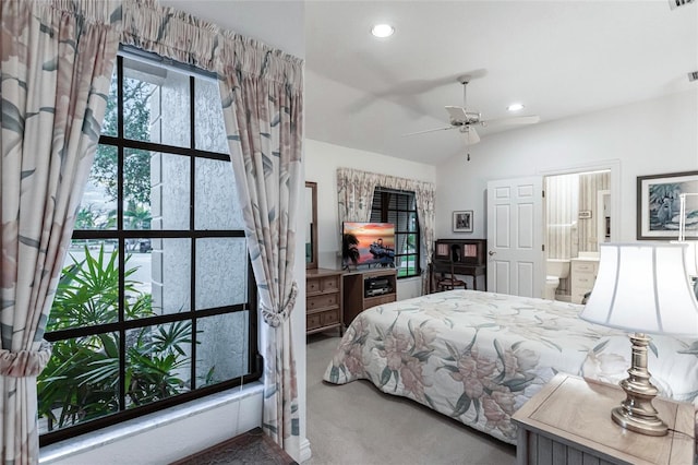 bedroom with carpet, ensuite bathroom, ceiling fan, and vaulted ceiling