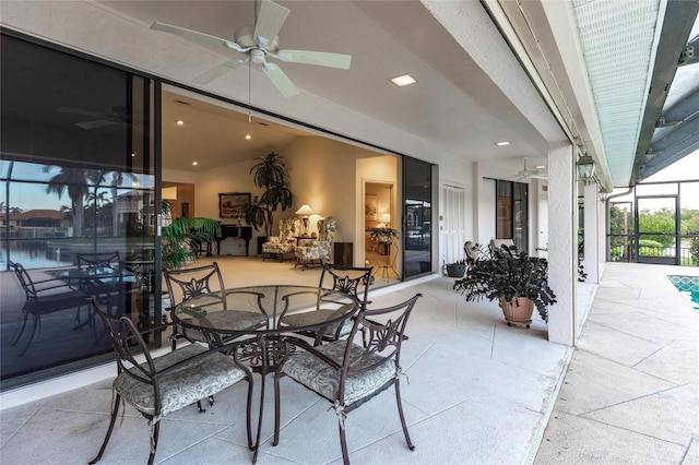 view of patio / terrace featuring ceiling fan and a lanai