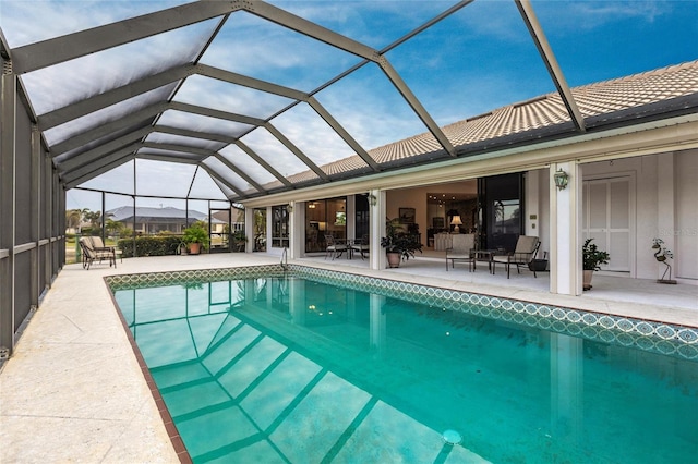 view of swimming pool with a lanai and a patio area