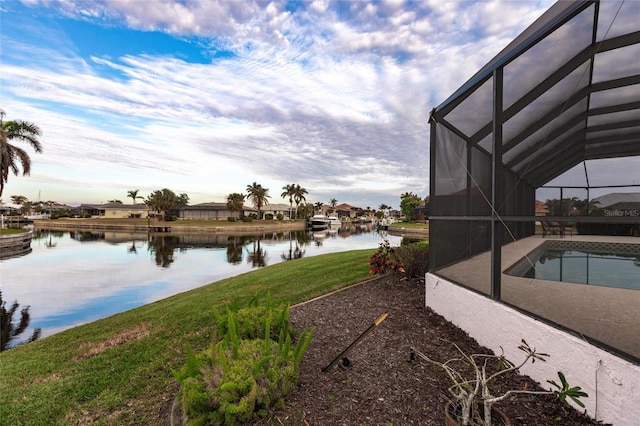 exterior space featuring glass enclosure and a water view