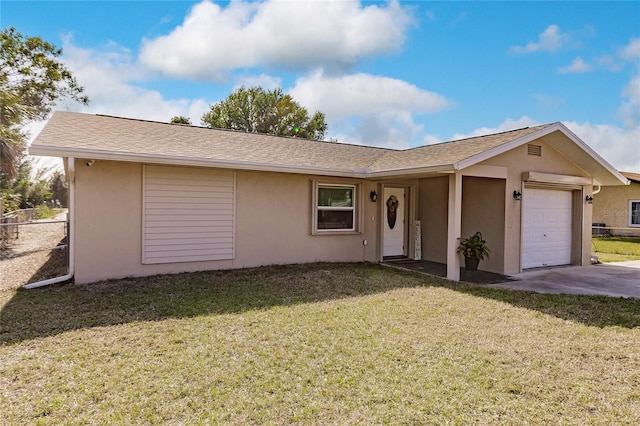 ranch-style house featuring a garage and a front lawn