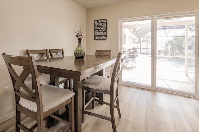 dining room featuring a healthy amount of sunlight and light hardwood / wood-style floors