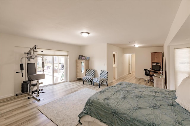 bedroom with access to outside and light hardwood / wood-style floors