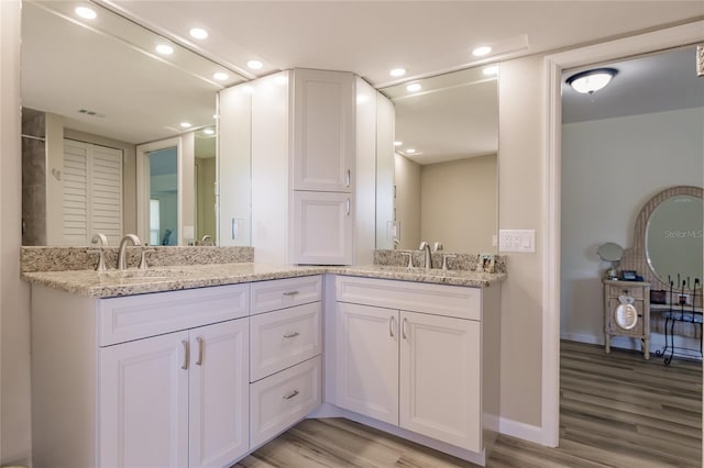 bathroom featuring hardwood / wood-style flooring and vanity