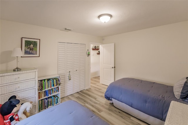 bedroom featuring a closet and light hardwood / wood-style flooring