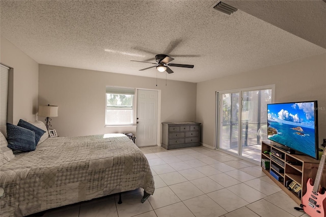 bedroom featuring access to outside, multiple windows, ceiling fan, and light tile patterned floors