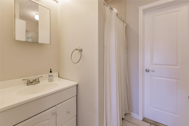 bathroom featuring tile patterned floors, vanity, and walk in shower