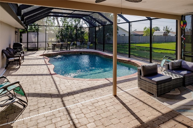 view of pool with a lanai, a storage unit, a patio area, and an outdoor hangout area