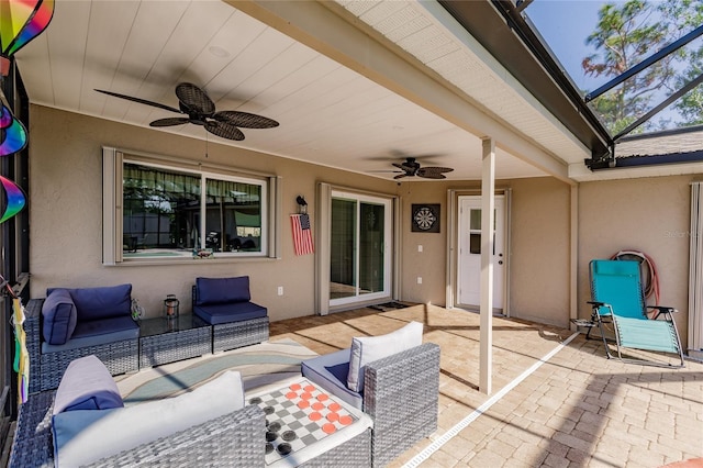 view of patio / terrace with an outdoor living space, ceiling fan, and a lanai