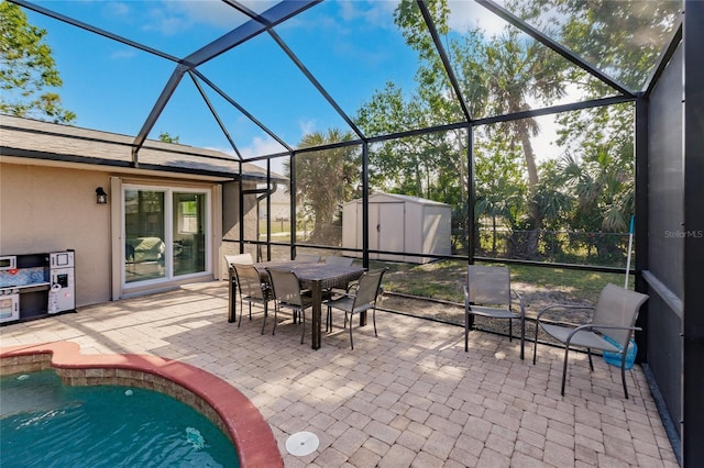 view of patio featuring glass enclosure and a storage unit