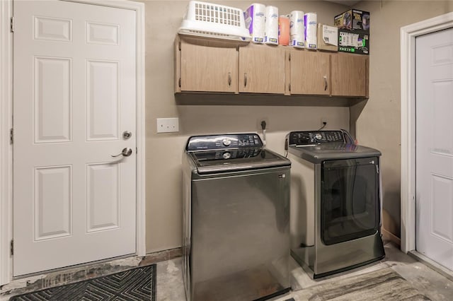 laundry area with cabinets and washing machine and clothes dryer