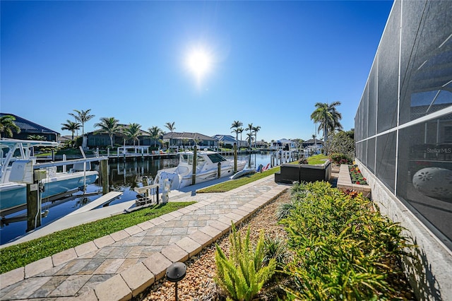 view of dock featuring a lanai and a water view