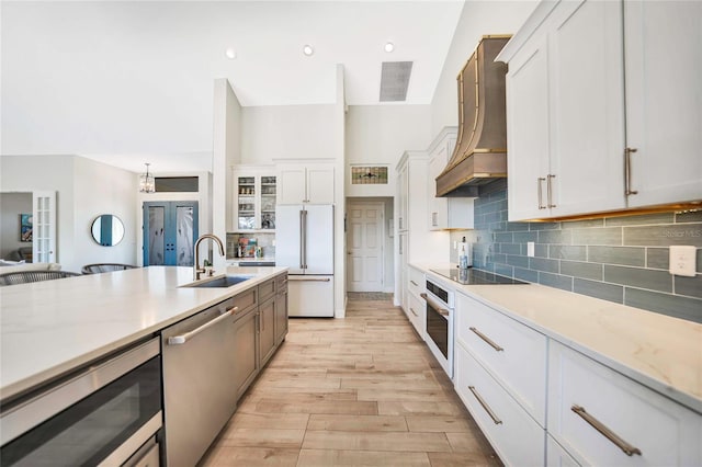 kitchen with white cabinets and custom exhaust hood