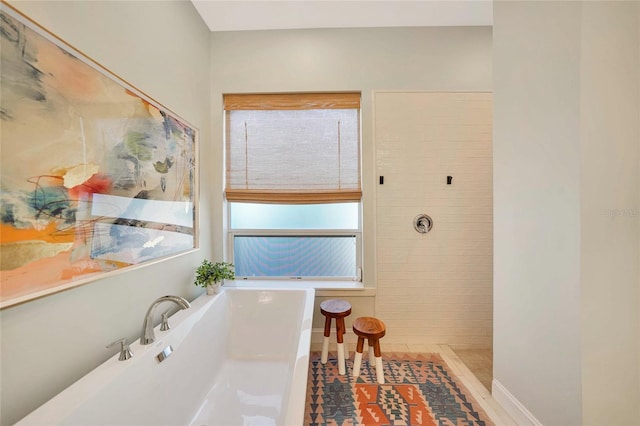 bathroom featuring separate shower and tub