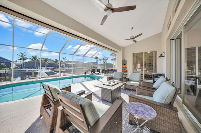 view of swimming pool featuring ceiling fan, a lanai, an outdoor hangout area, a patio area, and a water view