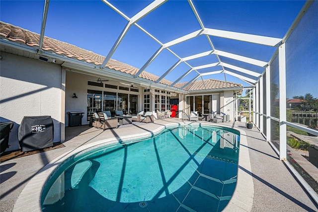 view of swimming pool featuring glass enclosure, ceiling fan, area for grilling, and a patio