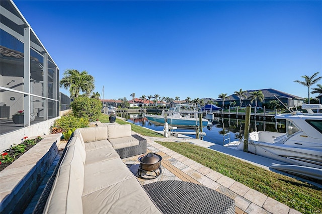 view of patio with glass enclosure, a water view, and a dock