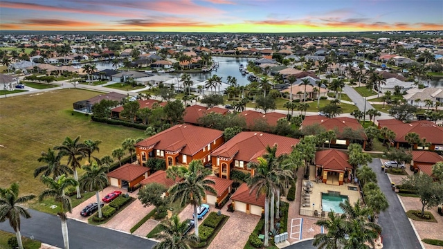 aerial view at dusk with a water view