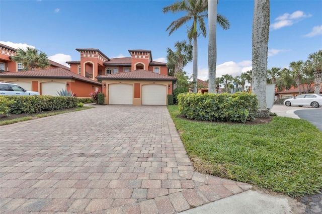 mediterranean / spanish-style home with a garage