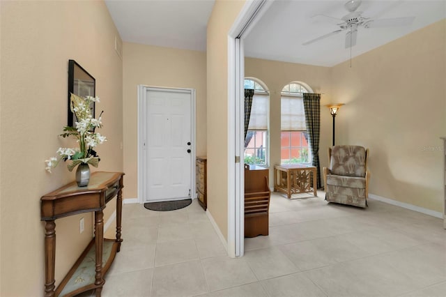 foyer with ceiling fan and light tile patterned floors