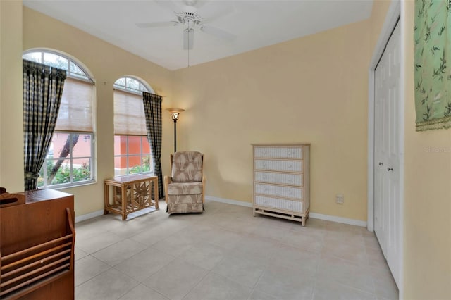 living area featuring ceiling fan and light tile patterned floors