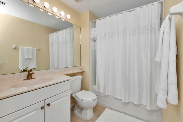 full bathroom featuring tile patterned floors, shower / tub combo with curtain, vanity, and toilet